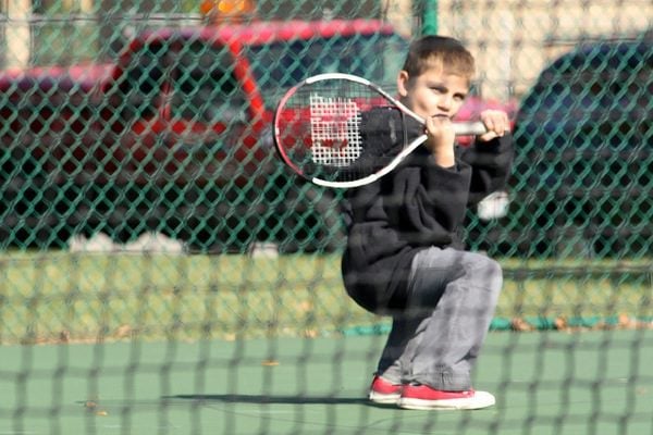 Kids excited about sports boy playing tennis