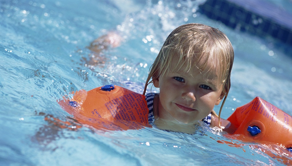 Young Girl Swimming with Water Wings ca. 2002