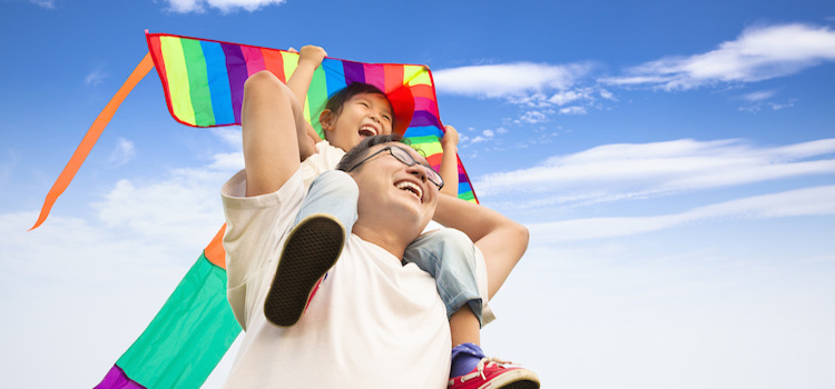 happy father and little girl with colorful kite