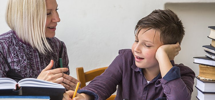 after school teacher helps child with homework
