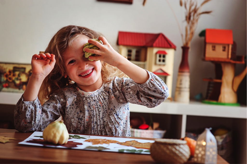 Girl having fun making fall crafts