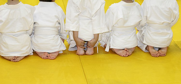 kids kneeling in martial arts class