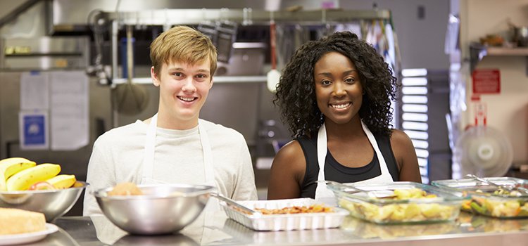 teens volunteering in a soup kitchen