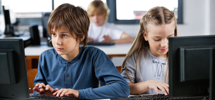 children learning to program computers at camp